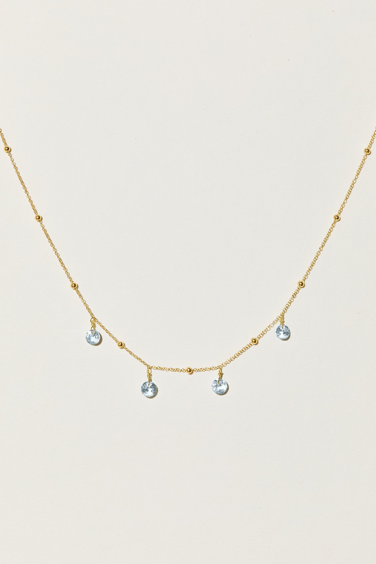 Liabelle 18K Goldkette mit hellblauen Topasen und filigranen Details